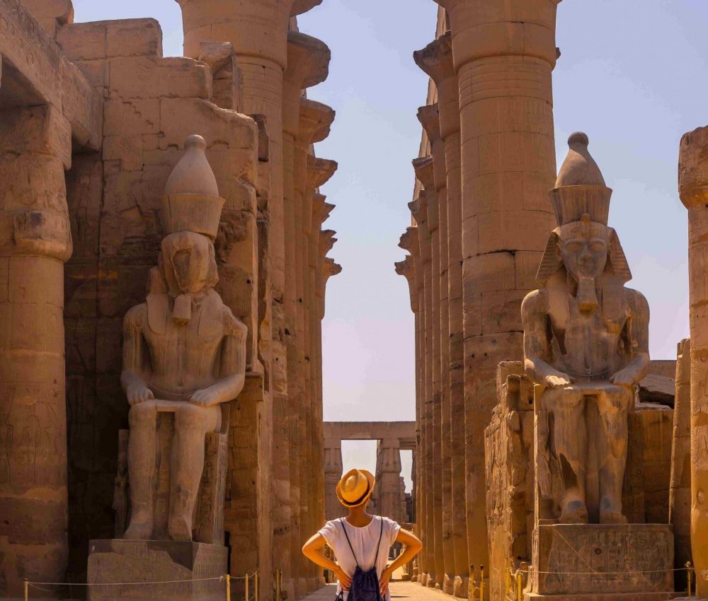 young-tourist-with-hat-visiting-egyptian-temple-luxor-its-beautiful-columns