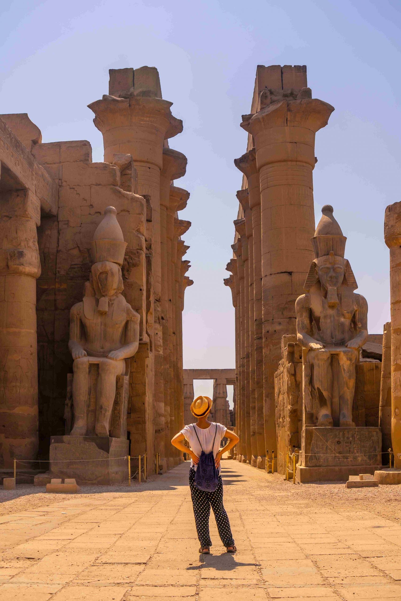 young-tourist-with-hat-visiting-egyptian-temple-luxor-its-beautiful-columns